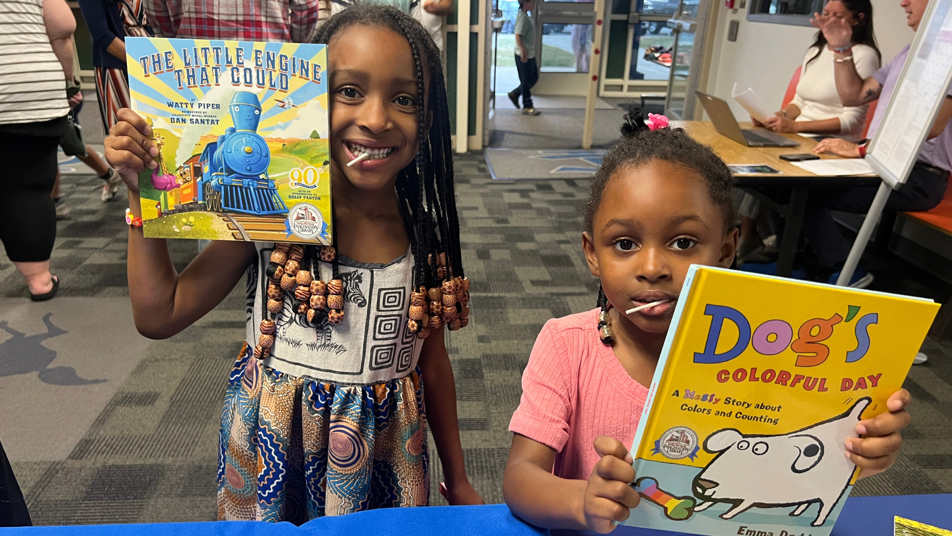two girls holding books