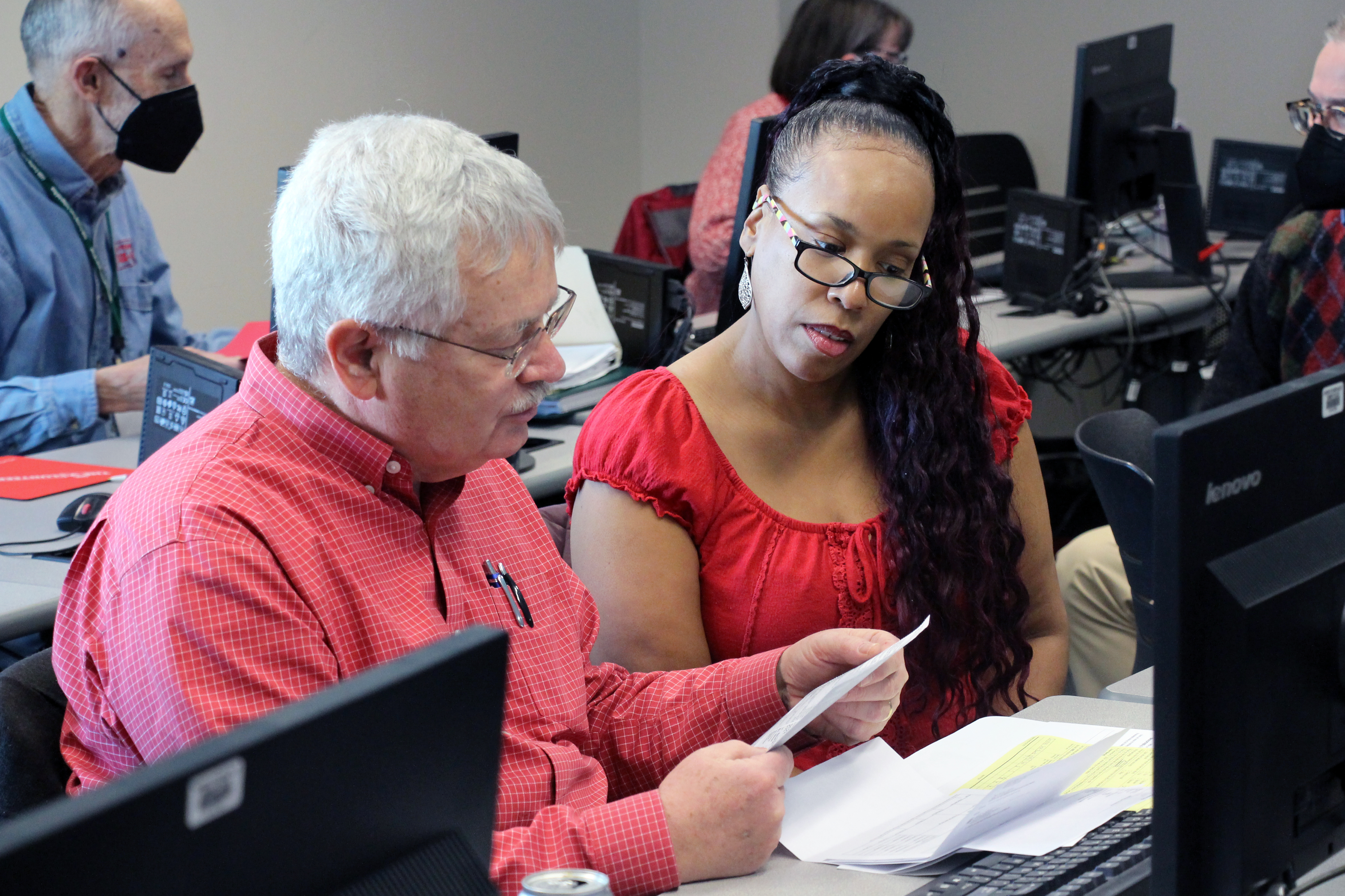 Man helping women file her taxes