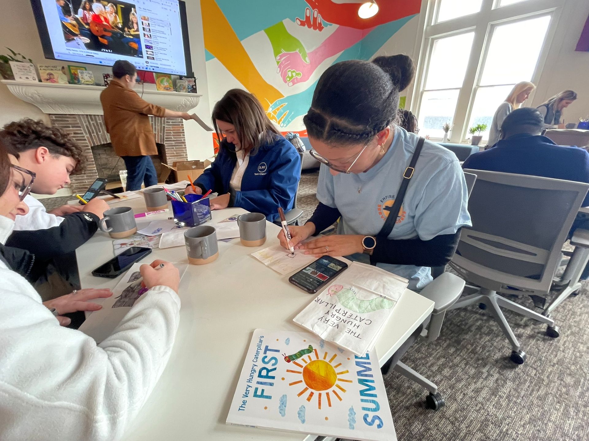 Volunteers decorating literacy bags