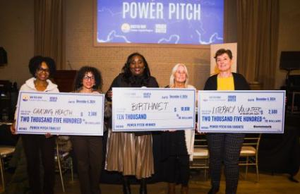 Power Pitch winners holding large checks