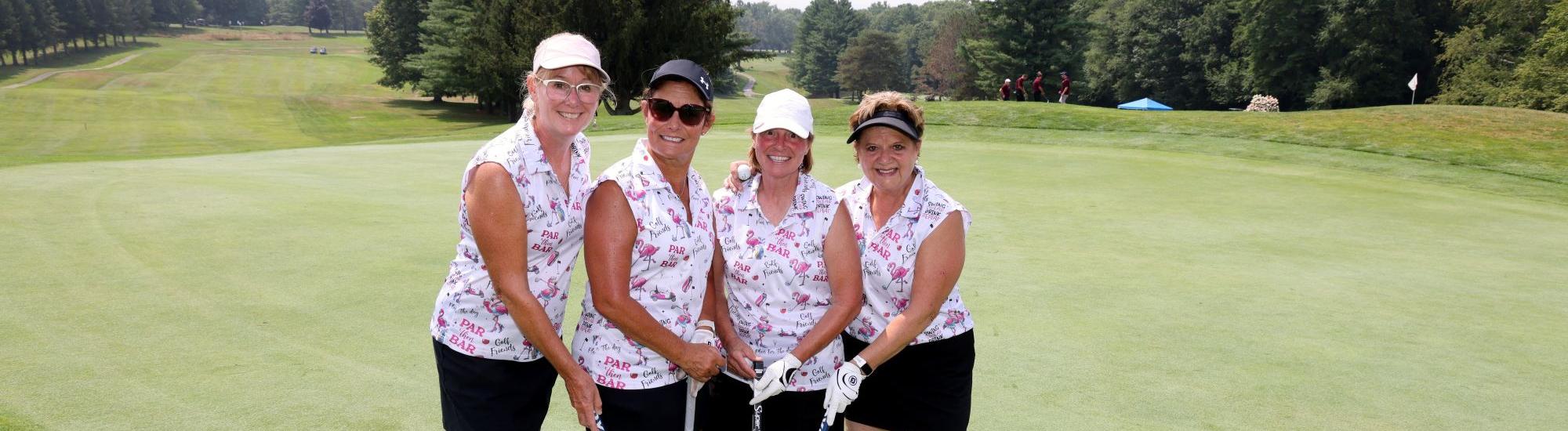 Group of women golfers in matching tank tops