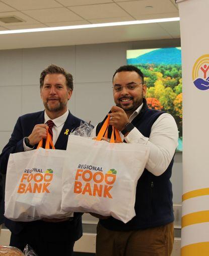 Peter and Michel-Aaron holding Food Bank bags filled with food