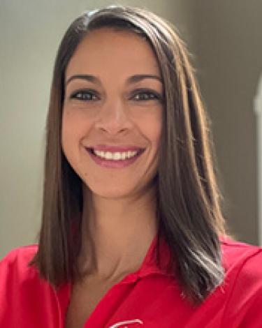 Alicia smiling in red shirt