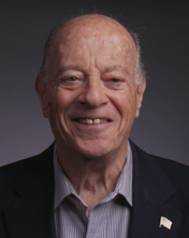 John smiling in black suit