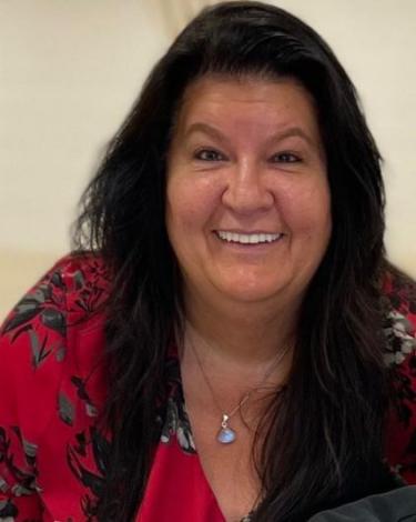 Bonnie smiling in red shirt